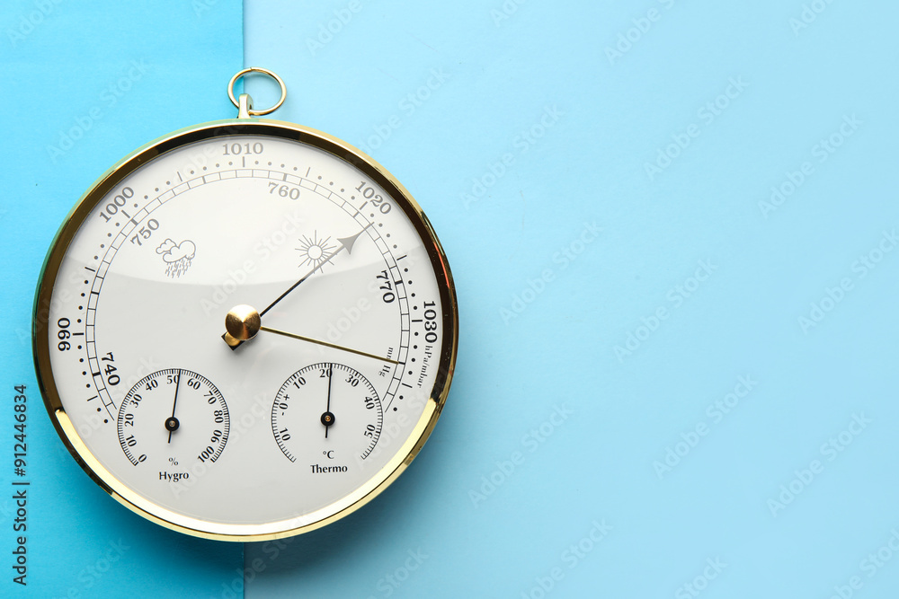 Aneroid barometer on blue background Aneroid barometer on blue background