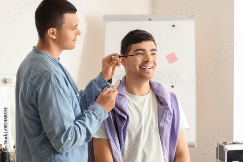 Male makeup artist working ...