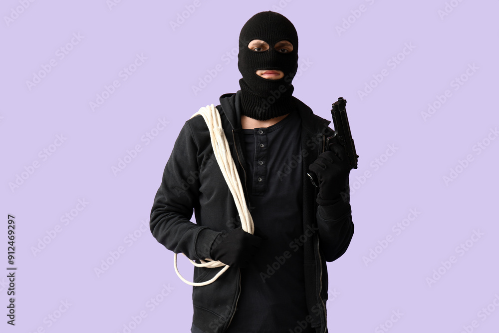 Male thief with rope and gun on lilac background Male thief with rope and gun on lilac background