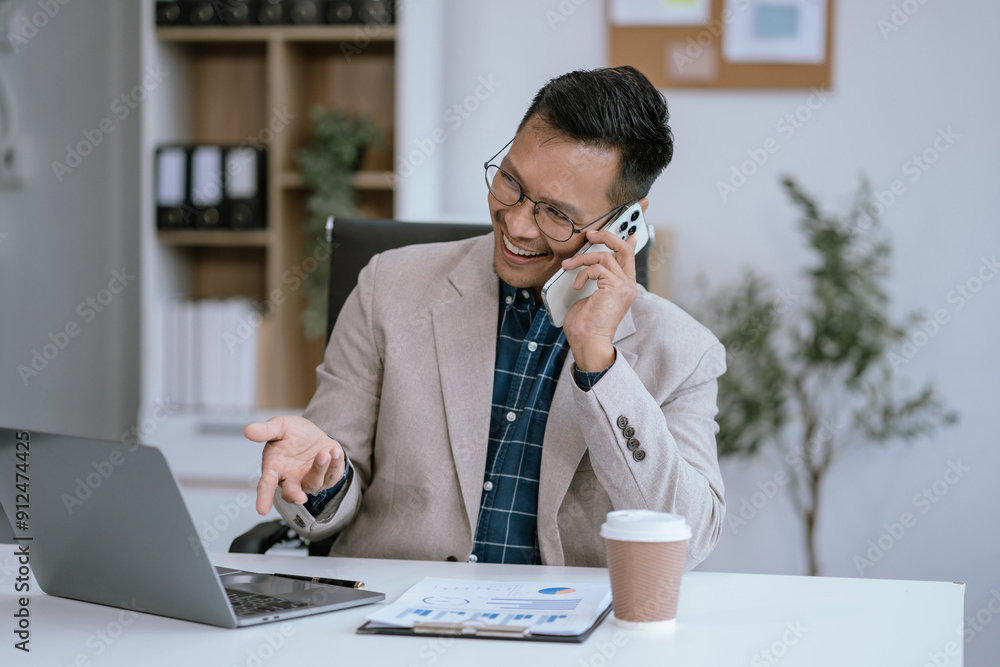 Male businessman talk mobile phones and working on laptop computers, online business, work from home, teleworking concept. Male businessman talk mobile phones and working on laptop computers, online business, work from home, teleworking concept.