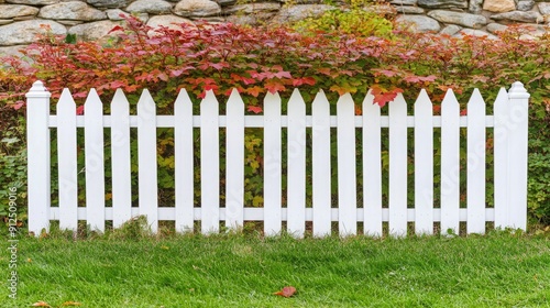 Charming White Picket Fence Surrounded by Autumn Foliage in a Serene Garden