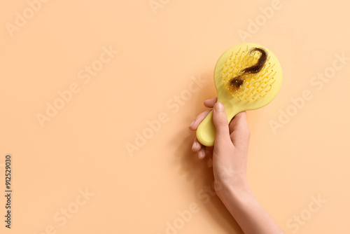 Canvas-taulu Hand with brush and clump of hair in shape of question mark on beige background