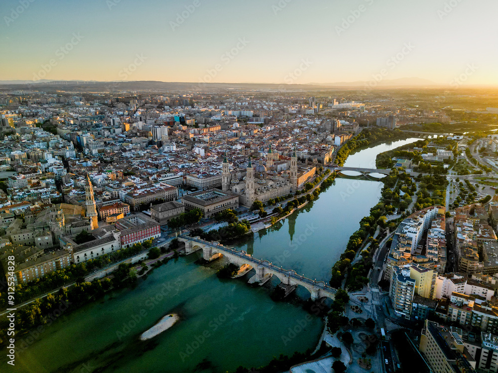 Spectacular Zaragoza city skyline at sunset. View of old town center, Cathedral of Zaragoza and Ebro River. Medieval and historic travel destination in Aragon - Spain. Sunset point, orange reflections Spectacular Zaragoza city skyline at sunset. View of old town center, Cathedral of Zaragoza and Ebro River. Medieval and historic travel destination in Aragon - Spain. Sunset point, orange reflections