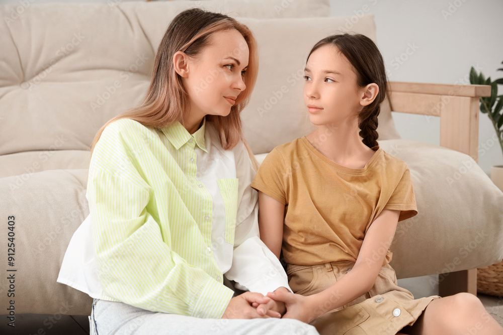 Teenage girl with her mother holding hands at home. Family difficulties concept Teenage girl with her mother holding hands at home. Family difficulties concept