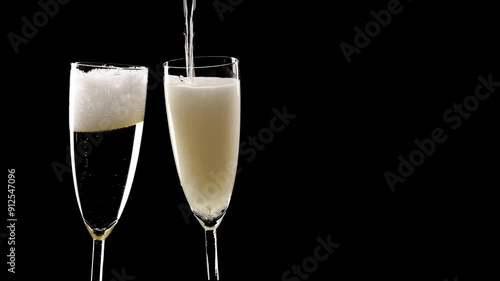 pouring champagne and toast with two glasses isolated on black background, fizzy drink motion design element overlay decoration texture for festive holiday events
