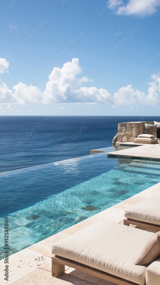 Fototapeta premium A luxurious infinity pool meets the calm ocean under a clear blue sky