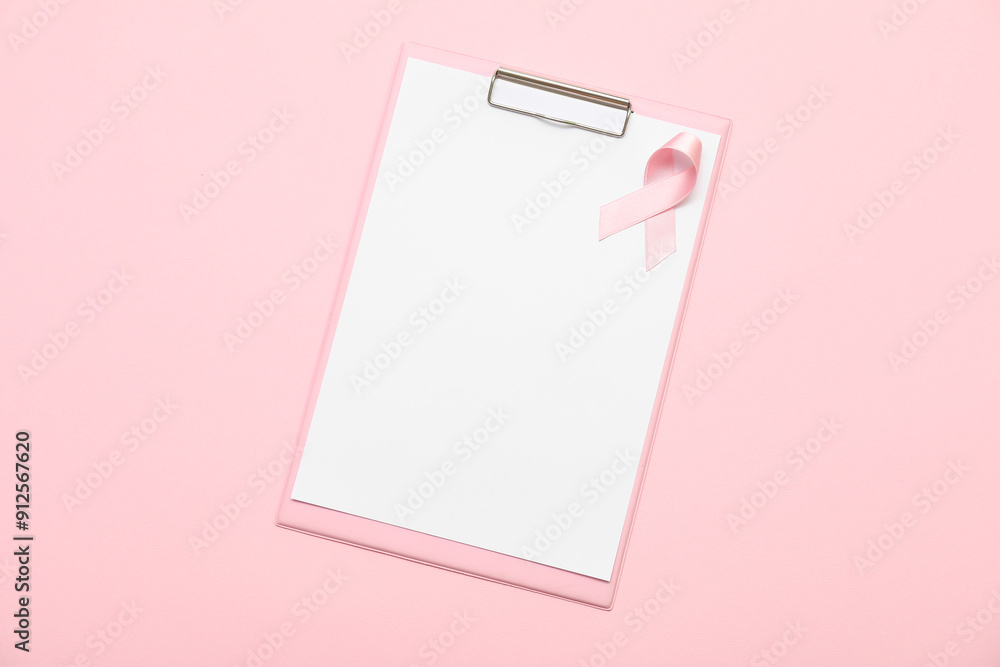 Blank clipboard with silk ribbon on pink background. Breast cancer concept Blank clipboard with silk ribbon on pink background. Breast cancer concept
