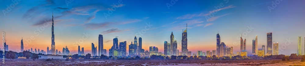 Panoramic image of the illuminated skyline of Dubai at dusk after sunset Panoramic image of the illuminated skyline of Dubai at dusk after sunset