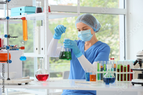 Female chemist with flask in laboratory