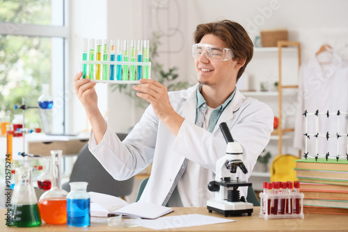 Male student in lab coat wi...
