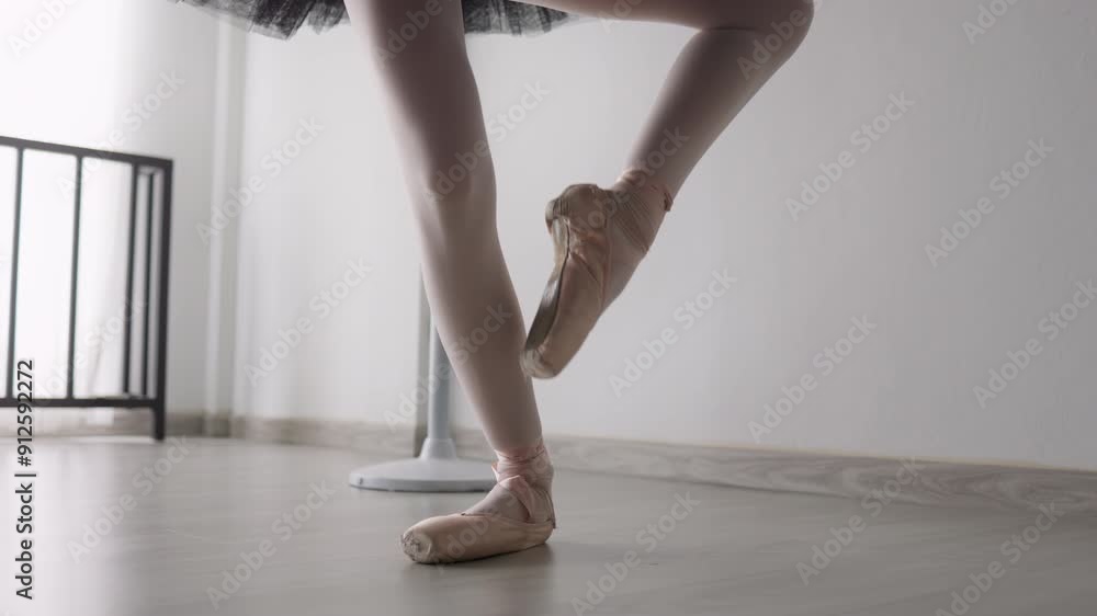 Ballerina's feet in pointe shoes practicing ballet in studio Ballerina's feet in pointe shoes practicing ballet in studio