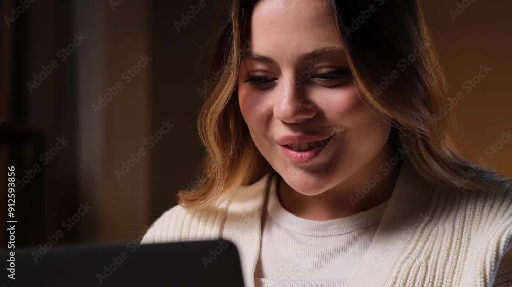 Portrait of a joyful Caucasian young woman, resting during late free time, using laptop for chatting in online cyberspace at home. Portrait of a joyful Caucasian young woman, resting during late free time, using laptop for chatting in online cyberspace at home.