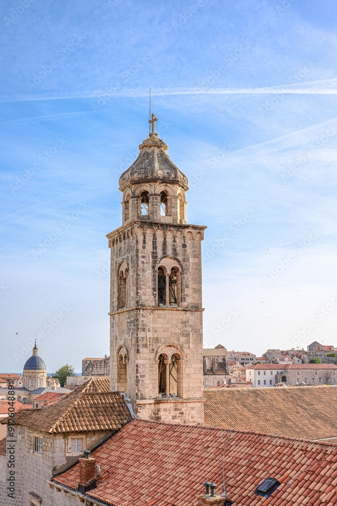 Historic bell tower in Dubrovnik, Croatia, under a clear blue sky with surrounding rooftops Historic bell tower in Dubrovnik, Croatia, under a clear blue sky with surrounding rooftops