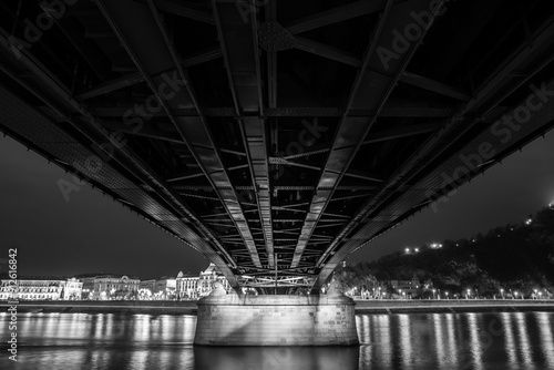A stunning night view of Budapest featuring the illuminated Chain Bridge and Gellért Hill, with the Danube River reflecting the city’s lights.