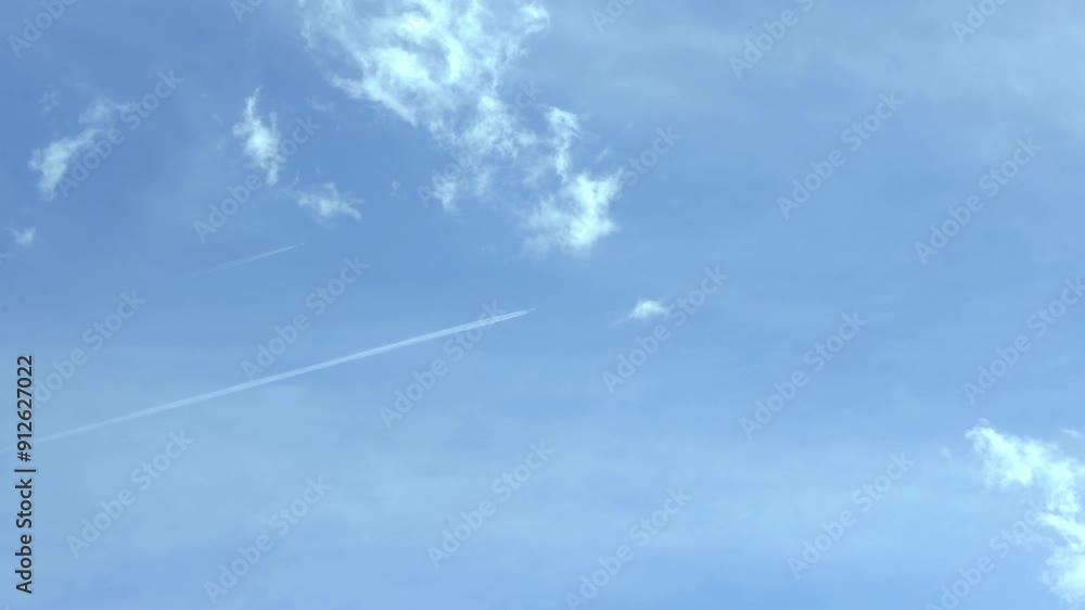 Two Airplanes Flying Parallel Over City with Blue Sky