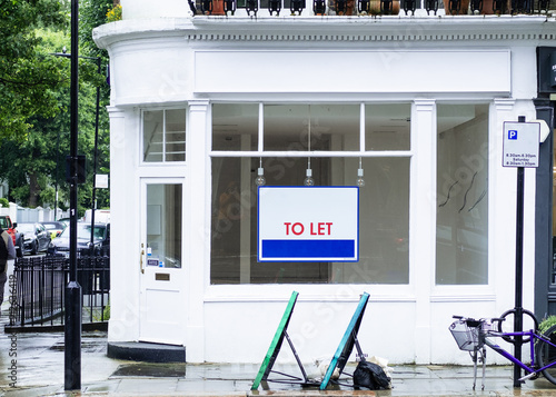 Vacant empty shop with To Let sign in shop window