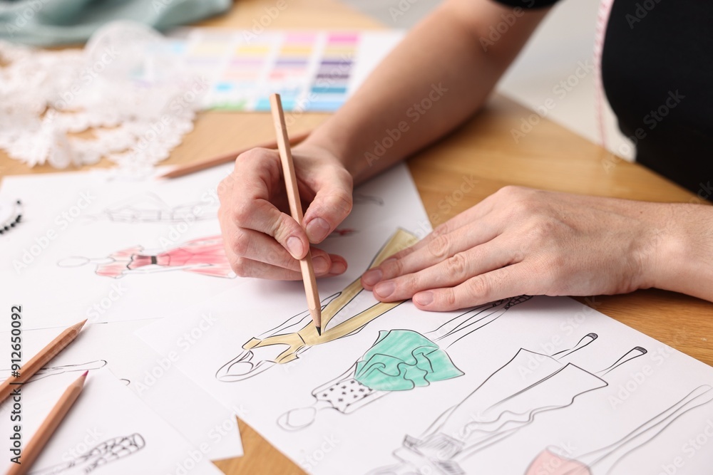 Fashion designer drawing sketch of beautiful dress at wooden table, closeup Fashion designer drawing sketch of beautiful dress at wooden table, closeup