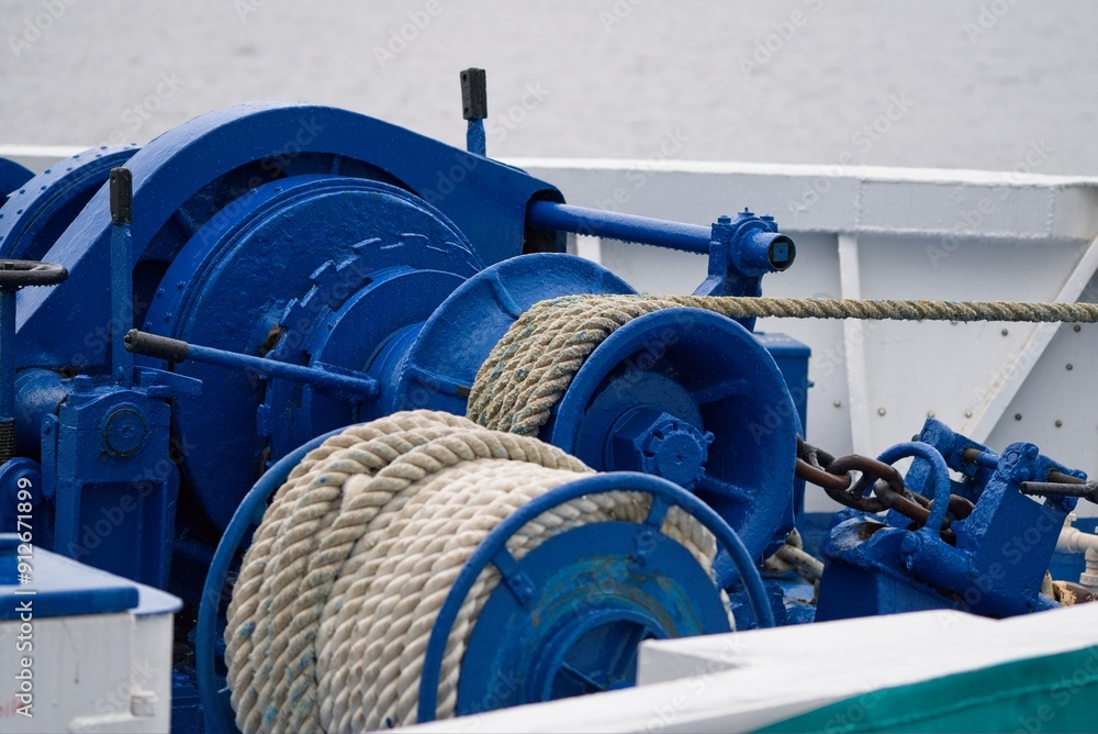 A ship's winch with ropes on the deck of a motor ship. A ship's winch with ropes on the deck of a motor ship.