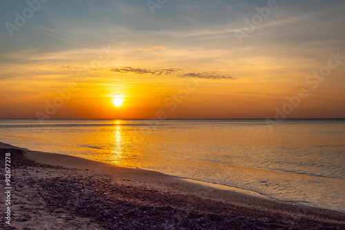 Sandy beach with pebbles of Baltic Sea on Curonian Spit at sunset. Kaliningrad region. Russia