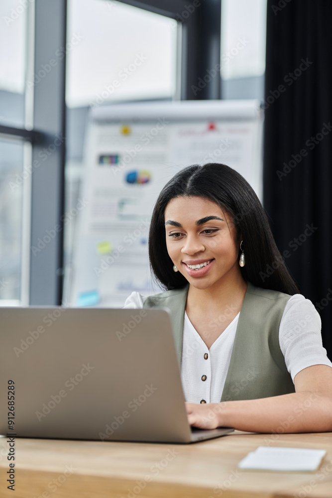 Smiling woman engaged in work at a contemporary office desk. Smiling woman engaged in work at a contemporary office desk.