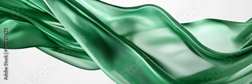 Flowing Emerald Green Fabric - Abstract Background - A close-up of a flowing emerald green fabric, creating a soft and elegant abstract background. The fabric's texture, light reflections, and gracefu photo