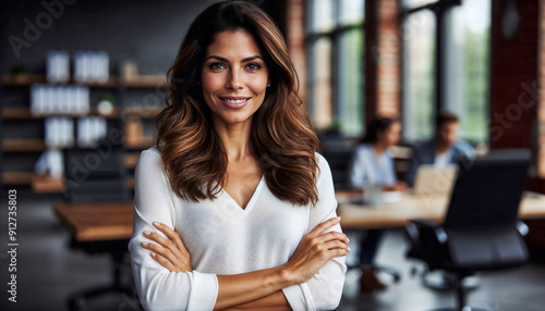 Beautiful Hispanic middle age businesswoman with crossed arms smiling in the office