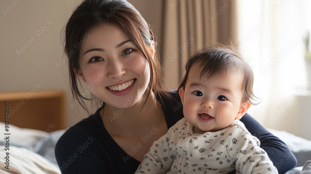 Joyful Japanese Woman and Adorable Baby Together on Bed Joyful Japanese Woman and Adorable Baby Together on Bed