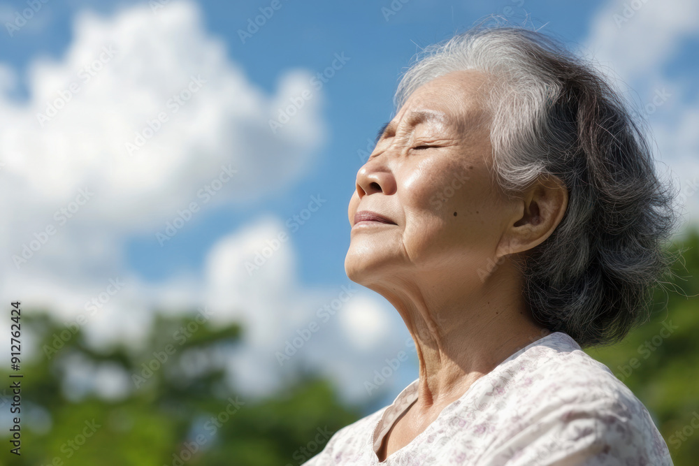 Malay senior woman taking a breath on a sunny day, mental health Malay senior woman taking a breath on a sunny day, mental health
