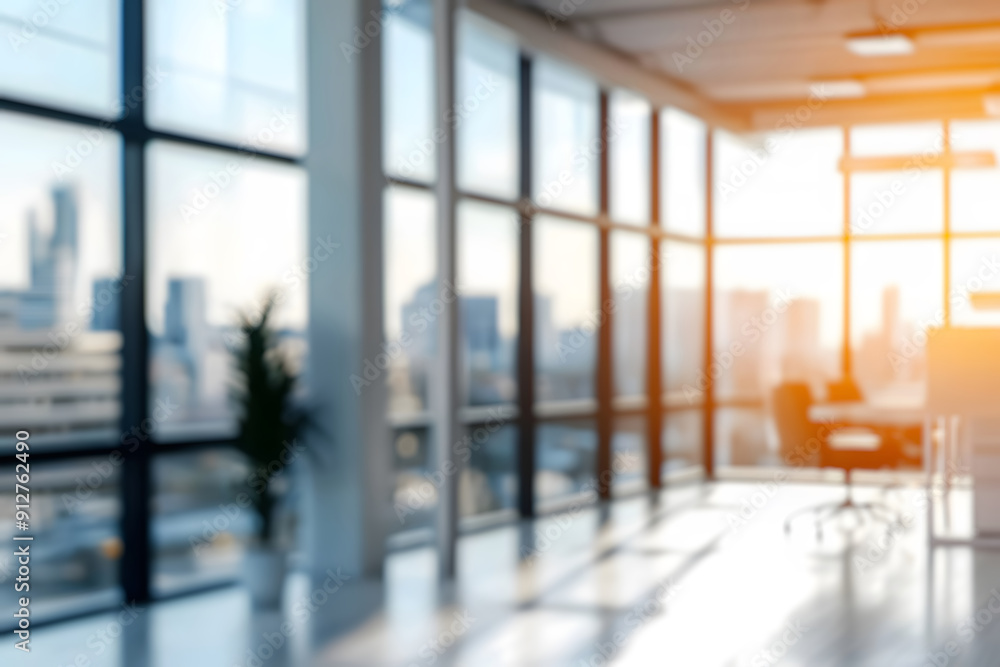Blurred sunlit modern office interior with glass walls, minimalist design, and distant city view through large windows. Blurred sunlit modern office interior with glass walls, minimalist design, and distant city view through large windows.