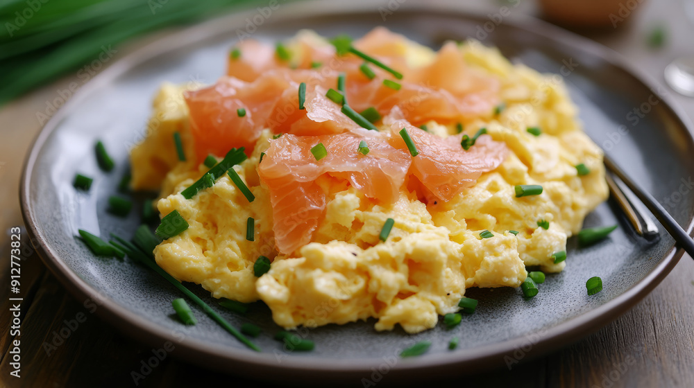 A plate of scrambled eggs with smoked salmon and chives A plate of scrambled eggs with smoked salmon and chives