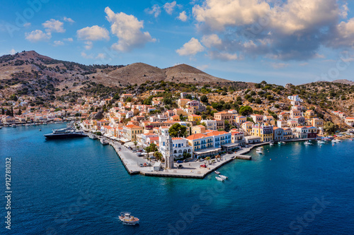 Wallpaper Mural View on Symi (Simi) island harbor port, classical ship yachts, houses on island hills, Aegean Sea bay. Greece islands holidays vacation travel tours from Rhodos island. Symi, Greece,  Dodecanese. Torontodigital.ca