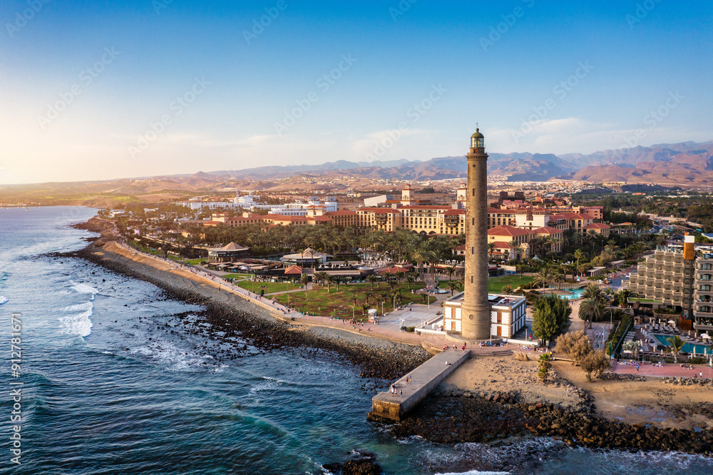 Lighthouse of Maspalomas at Gran Canaria Island known as Faro de Maspalomas at sunset. Seascape with lighthouse and Maspalomas beach. Gran Canaria, Canary Islands, Spain