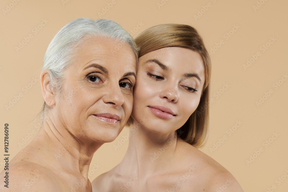 A mature woman and her daughter share a warm and joyful embrace. A mature woman and her daughter share a warm and joyful embrace.