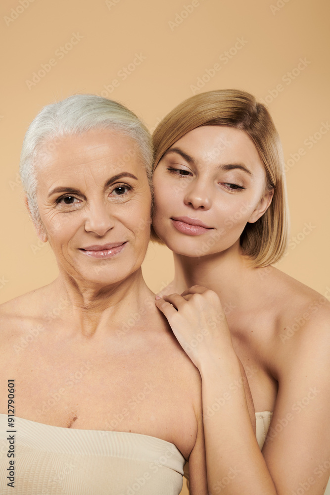 A mature woman and her adult daughter share a tender moment together. A mature woman and her adult daughter share a tender moment together.
