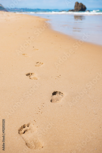 Footprints on the sandy beach. Footsteps in soft sand. 