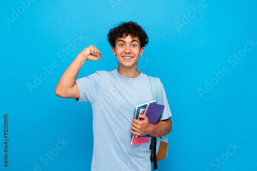 Fotografija Smiling boy guy high school male pupil student teenager with backpack holding bo