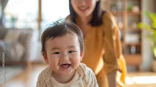 A smiling little baby with his mother on the background