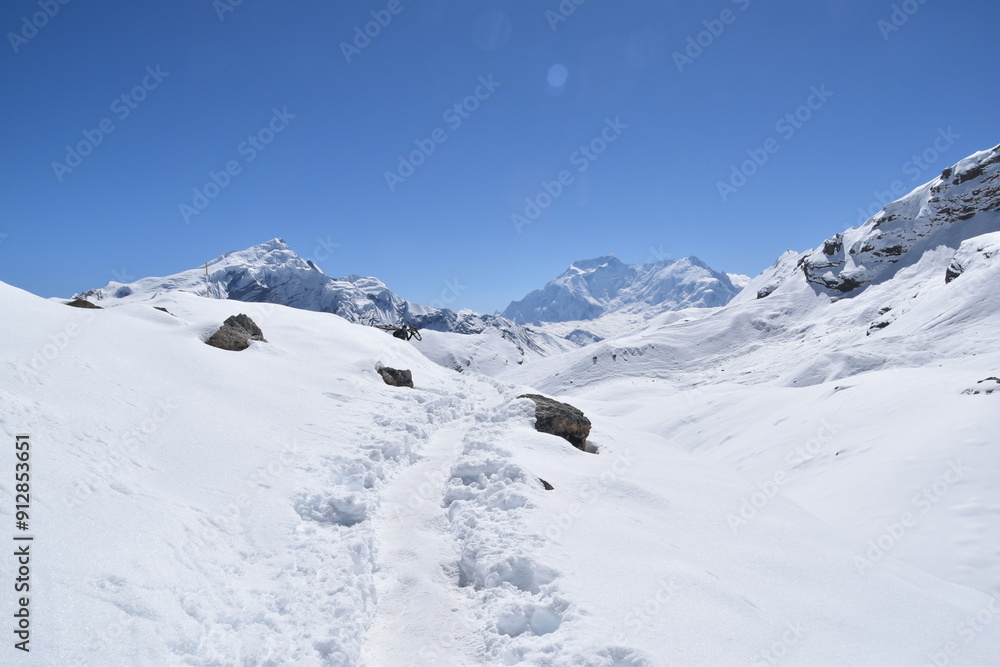 A hiking trail where the path leads towards the mountains A hiking trail where the path leads towards the mountains