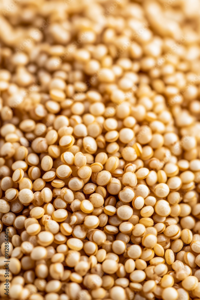 Macro shot of the texture of quinoa displaying the tiny round grains with a creamy white hue and subtle ridges Macro shot of the texture of quinoa displaying the tiny round grains with a creamy white hue and subtle ridges