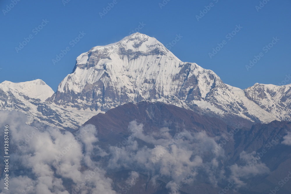 Sunset over the top of Annapurna IV mountain and its snowy glaciars turning orange