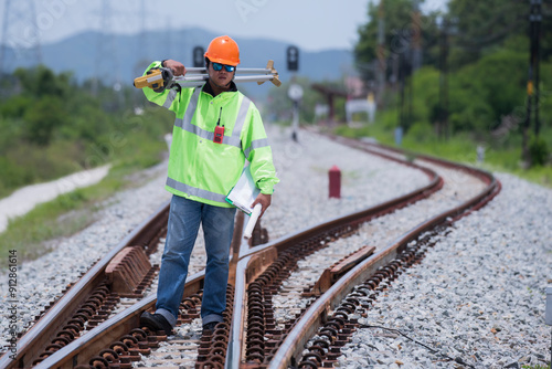 Surveyor builder site engineer with theodolite total station at Railway site outdoors during surveying work