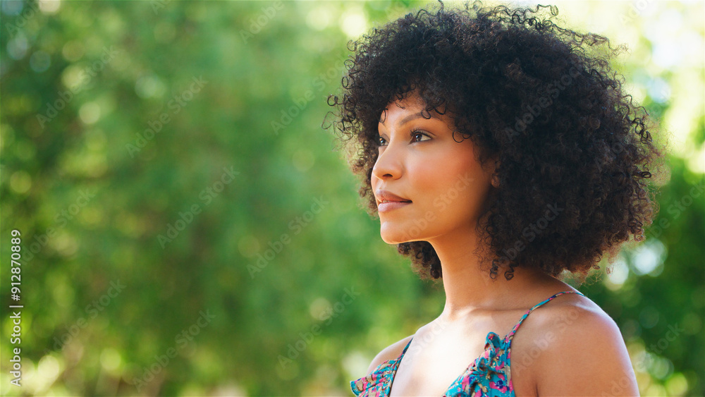 Young Woman With Curly Hair Enjoying Nature in a Sunny Park Young Woman With Curly Hair Enjoying Nature in a Sunny Park