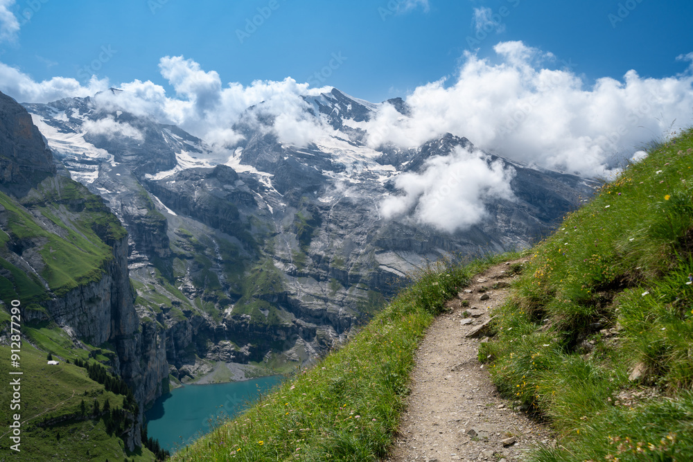 Naklejka premium Oeschinensee Lake hike in Switzerland, near Kandersteg in the Swiss Alps, wildflowers on the trail