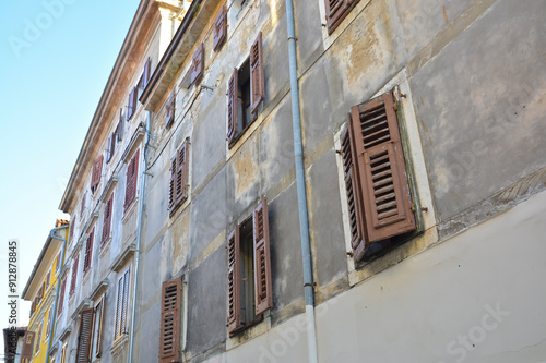 This is a large building that features numerous windows and shutters