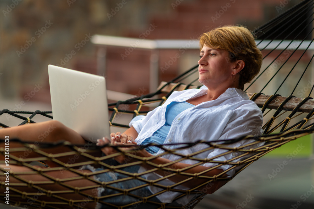 A woman looks through her laptop.