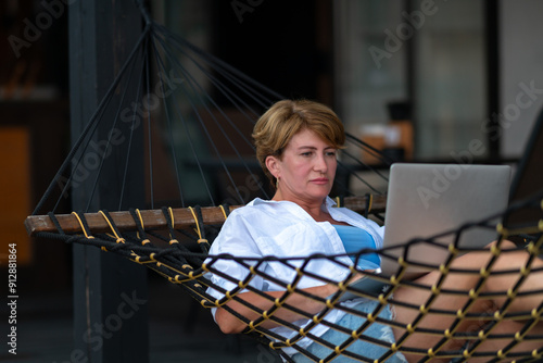 Obraz na płótnie Woman with laptop in hammock. w salonie