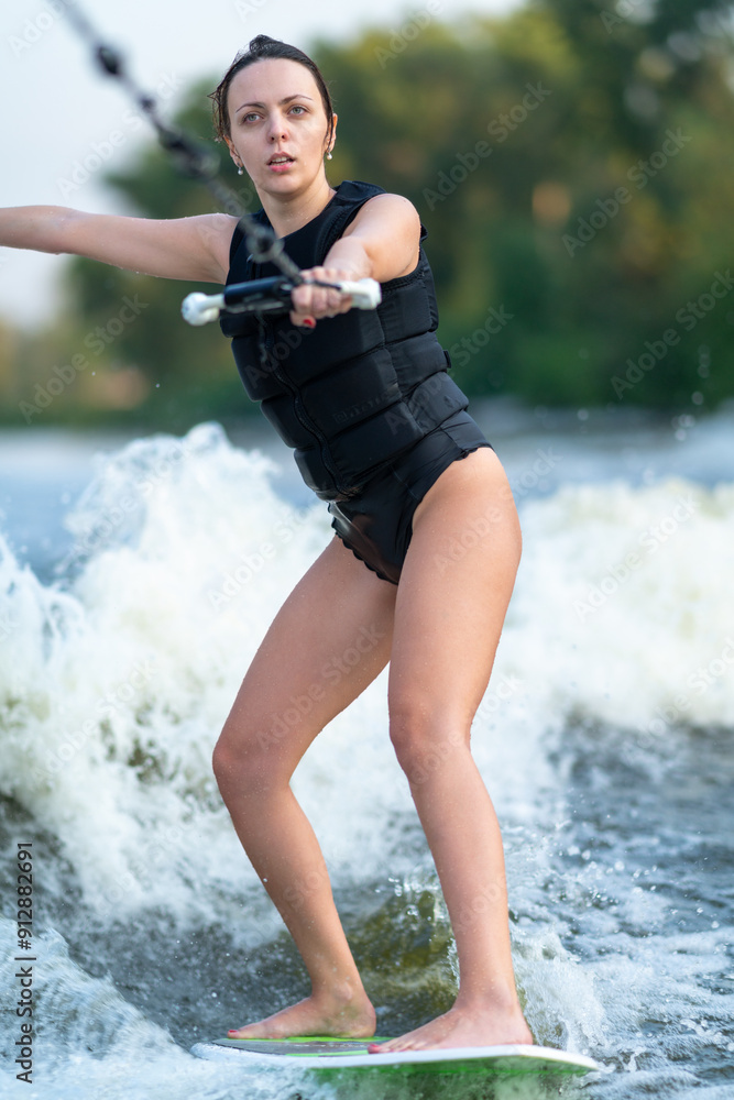 A wakeboarder rides behind a boat.