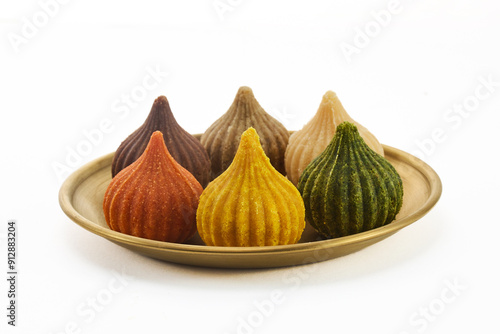 Ganesh Chaturthi Festival. Colorful Modaks Indian sweet dumpling on Plate