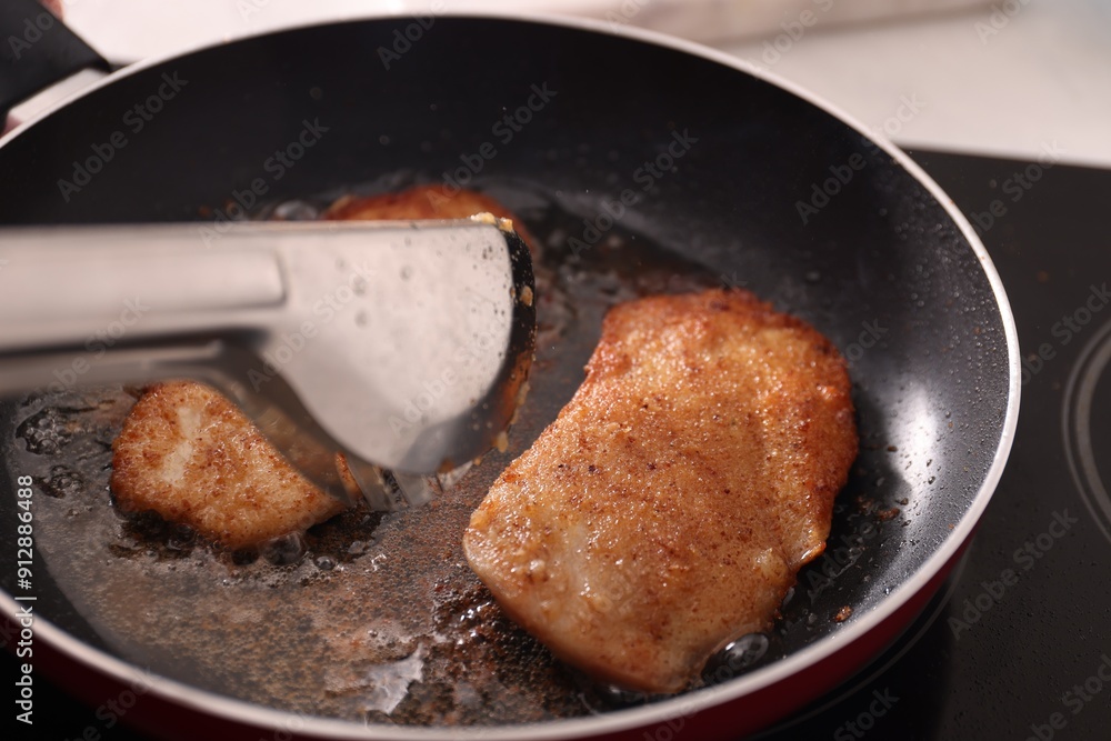 Schnitzels cooking in frying pan on stove, closeup Schnitzels cooking in frying pan on stove, closeup