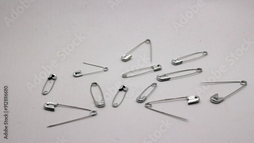 The safety pin is made of metal and silver in color.